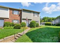 Charming townhouse featuring well-maintained landscaping and a welcoming entrance at 6044 Heath Valley Rd, Charlotte, NC 28210