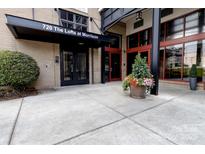 The building entrance at 720 The Lofts at Morrison with flower display and black awning at 720 Governor Morrison St # 221, Charlotte, NC 28211
