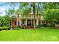 Stately brick home with lush green lawn and mature landscaping, offering timeless elegance at 748 Land Fall Dr, Rock Hill, SC 29732