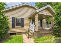 Charming single-story home featuring a covered front porch with decorative white picket fence at 807 3Rd St, Kings Mountain, NC 28086