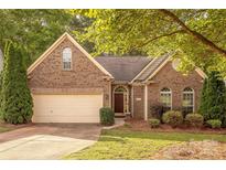 Charming brick home with manicured lawn and attached garage, offering classic curb appeal at 901 Clearbrook Rd, Matthews, NC 28105