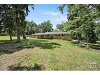 Charming home featuring a welcoming front deck and lush, tree-filled surroundings at 926 Meadow Lakes Rd, Rock Hill, SC 29732