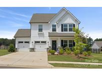 Charming two-story home featuring a three-car garage and beautifully landscaped front yard at 12001 Sam Snead Ct, Lancaster, SC 29720