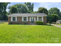 Charming brick home with well-manicured lawn and classic white shutters at 1218 Milan Rd, Charlotte, NC 28216