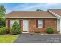 Charming brick townhouse with manicured landscaping and a well-maintained front yard at 130 24Th Nw St, Hickory, NC 28601