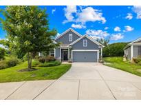 Charming single-Gathering home with a well-manicured lawn, mature tree and a two car garage, offering great curb appeal at 138 Chase Water Dr, Mooresville, NC 28117