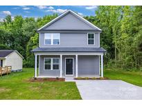 Charming two-story home features a well-maintained lawn, covered porch and inviting curb appeal at 1420 Tyler St, Kannapolis, NC 28083