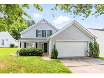 Charming two-story home with light blue siding, black shutters, and a well-manicured front yard at 1515 Kingdom Way, Fort Mill, SC 29707