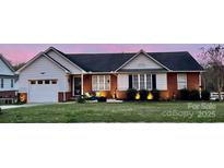 Charming single-story home with brick accents, well-maintained lawn, and inviting front porch at 1700 Pickwick Ave, Kannapolis, NC 28083