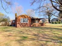Cozy brick home featuring a front porch and a well-maintained front yard at 176 Travis Loop, Statesville, NC 28625
