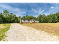 Charming single-Gathering home with gravel driveway and welcoming front entrance at 2007 Sugar Hill Rd, York, SC 29745