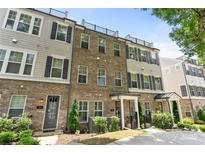 Brick townhome with black shutters and wrought-iron railings, offering a modern and stylish facade at 318 N Dotger Ave, Charlotte, NC 28204