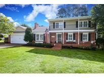 Charming brick home boasts a spacious front lawn, a second-story porch, and an inviting entrance for relaxing or entertaining at 3604 Golfview Dr, Gastonia, NC 28056