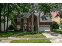 Charming brick home featuring a well-manicured lawn and a two-car garage at 3810 Yorkford Dr, Charlotte, NC 28269