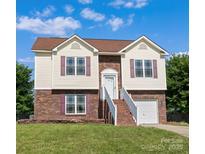 Charming two-story home boasts a brick facade, light siding, and lovely landscaping at 4111 Alexis Sw Ct, Concord, NC 28027