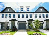Stylish townhome featuring a painted brick facade, multiple windows, and a well-manicured lawn at 4714 Blanchard Way, Charlotte, NC 28226
