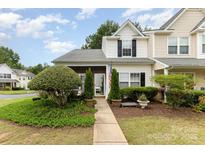 Charming townhome with manicured front yard and walkway leading to the welcoming entrance at 6103 Warrior Ave, Fort Mill, SC 29707