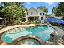 Stunning backyard pool and hot tub area with a screened porch in a beautiful setting at 9009 Salford Ct, Huntersville, NC 28078
