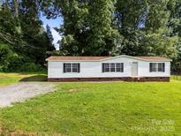 Charming single-story home with a well-maintained lawn and mature trees at 1011 Rachel Ln, Salisbury, NC 28147