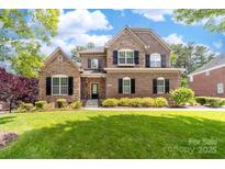 Charming two-story brick home with manicured lawn and landscaping, perfect curb appeal at 10321 Lemington Dr, Mint Hill, NC 28227