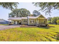 Charming single-story home with a well-manicured front lawn, carport, and inviting entrance at 2105 Florida Ave, Kannapolis, NC 28083