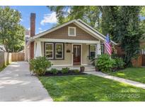 Charming craftsman-style home with a landscaped front yard, inviting porch, and a classic brick chimney at 2112 Shenandoah Ave, Charlotte, NC 28205