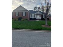 Charming brick home with a well-manicured lawn and inviting front porch at 2300 Wednesbury Ct, Kannapolis, NC 28083