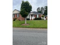 Charming single-story brick home with a well-maintained lawn and inviting front porch at 2300 Wednesbury Ct, Kannapolis, NC 28083