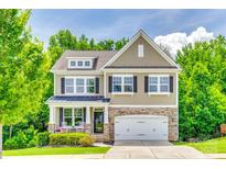 Charming two-story home with a stone-accented facade, black shutters, and a well-manicured front yard at 2816 Woodlands Creek Dr, Monroe, NC 28110
