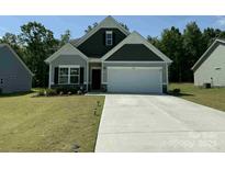 Charming single-Gathering home featuring a two-car garage, well-maintained lawn, and inviting curb appeal at 2921 Parkwest Dr, Albemarle, NC 28001
