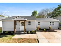 Charming single-story home featuring a welcoming front porch and well-maintained landscaping at 300 Cherry St, Belmont, NC 28012
