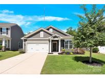 Charming single-Gathering home with manicured lawn and inviting curb appeal on a sunny day at 3207 Selwyn Landing Dr, Charlotte, NC 28215