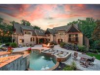 Stunning backyard with a luxurious pool, spa, fire pit, and ample seating for entertaining at 3587 Ridgetop Rd, Sherrills Ford, NC 28673