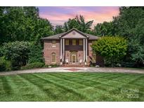 Stately brick home with manicured lawn and grand entrance exudes timeless elegance at 408 Johnsfield Rd, Shelby, NC 28150