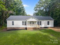 Charming one-story home featuring a classic white exterior, a welcoming front porch, and a well-manicured front lawn at 442 Lovelace Rd, Rock Hill, SC 29730