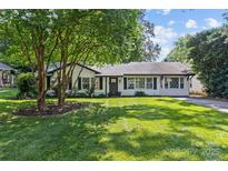 Charming single-story home featuring mature trees, a lush green lawn, and classic curb appeal at 5329 Valley Forge Rd, Charlotte, NC 28210