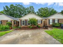 Charming brick home with manicured landscaping and a concrete driveway at 656 Ne Camrose Ne Cir, Concord, NC 28025