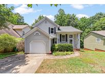 Charming single Gathering home with inviting curb appeal, attached garage and lush landscaping at 7425 Hubbard Woods Rd, Charlotte, NC 28269