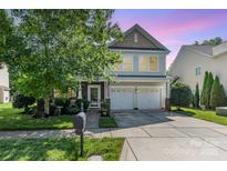 Charming two-story home featuring a two-car garage, landscaped yard and inviting front porch at 10237 Broken Stone Ct, Charlotte, NC 28214