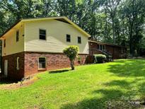 Two-story home shows siding and brick exterior with a well maintained lawn and mature trees at 237 Antietam Rd, Statesville, NC 28625