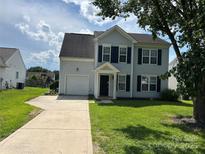 Charming two-story home featuring a well-manicured lawn and a convenient attached garage at 2819 Cougar Hill Ct, Charlotte, NC 28216