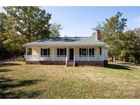 Charming single-story home featuring a inviting front porch and well-maintained yard, perfect for southern living at 3330 Clinzo Feemster Rd, Hickory Grove, SC 29717