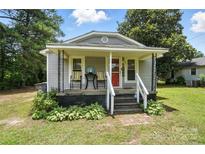 Charming single-story home with a welcoming covered porch and a red front door at 407 Rosemont Ave, Kannapolis, NC 28081