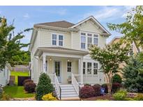 Charming two-story home with a inviting front porch, colorful landscaping, and a well-maintained lawn at 827 Digby Rd, Rock Hill, SC 29730