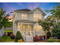 Charming two-story home featuring a welcoming front porch and beautifully landscaped yard at 827 Digby Rd, Rock Hill, SC 29730