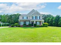 Charming two-story home with landscaped front yard, traditional design and inviting curb appeal at 11922 Kimberfield Rd, Matthews, NC 28105