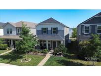 Charming two-story home featuring well-maintained landscaping and a welcoming front porch at 11965 Hambright Rd, Huntersville, NC 28078