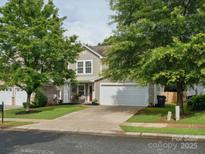 Charming two-story home with a well-manicured lawn and a two-car garage at 13314 Pontchatrain Ave, Charlotte, NC 28273