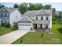 Beautiful two-story home with a well-manicured lawn and two-car garage, great curb appeal at 171 Old Harbor Dr, Mount Gilead, NC 27306