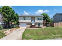 Charming split-level home with brick and vinyl siding, complemented by green shutters and a well-manicured lawn at 23 Redwood Ct, Alexander, NC 28601
